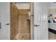 Bathroom featuring a walk-in shower with travertine tile and a convenient built-in niche at 290 Dornoch Dr., Pawleys Island, SC 29585