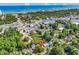 An aerial view of a house surrounded by trees, showing the neighborhood and city skyline in the distance at 3001 Wiley Dr., North Myrtle Beach, SC 29582