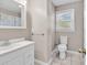 Bright bathroom featuring a vanity with mirror, toilet, and shower with curtain at 3001 Wiley Dr., North Myrtle Beach, SC 29582