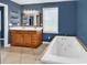 Elegant bathroom with double sink vanity, jacuzzi tub, and large window allowing natural light at 3001 Wiley Dr., North Myrtle Beach, SC 29582