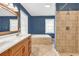 Bright bathroom featuring double sinks, jacuzzi tub, decorative mirror, and tiled shower stall at 3001 Wiley Dr., North Myrtle Beach, SC 29582