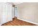 Neutral bedroom with hardwood floors, a louvered closet, and doorway to another room at 3001 Wiley Dr., North Myrtle Beach, SC 29582