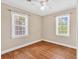 Comfortable bedroom with hardwood floors, two windows, and a ceiling fan at 3001 Wiley Dr., North Myrtle Beach, SC 29582