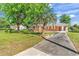 Charming brick home with a well-manicured lawn and a paved driveway with mature shade trees at 3001 Wiley Dr., North Myrtle Beach, SC 29582
