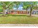 Charming single-story brick home featuring a lush, green lawn and mature trees at 3001 Wiley Dr., North Myrtle Beach, SC 29582