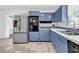 Bright kitchen featuring stainless steel appliances, ample countertop space, and light blue cabinets at 3001 Wiley Dr., North Myrtle Beach, SC 29582