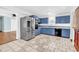 Modern kitchen boasting stainless steel refrigerator, black dishwasher, tile flooring, and blue cabinets at 3001 Wiley Dr., North Myrtle Beach, SC 29582