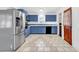 Stylish kitchen featuring blue cabinets, stainless steel appliances, and tiled floors at 3001 Wiley Dr., North Myrtle Beach, SC 29582