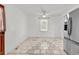 Open kitchen area with stainless steel refrigerator, tiled floors, and window for natural light at 3001 Wiley Dr., North Myrtle Beach, SC 29582
