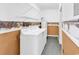 Functional laundry room equipped with washer, dryer, water heater and wire shelving at 3001 Wiley Dr., North Myrtle Beach, SC 29582