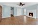 Bright living room with hardwood floors, a ceiling fan, and a cozy fireplace at 3001 Wiley Dr., North Myrtle Beach, SC 29582