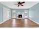 Light-filled living room with hardwood floors, fireplace, and double doors to outside at 3001 Wiley Dr., North Myrtle Beach, SC 29582