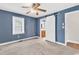 Stylish bedroom with hardwood floors, barn door to en-suite bathroom, and a ceiling fan at 3001 Wiley Dr., North Myrtle Beach, SC 29582