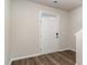A bright entryway with a white door, wood-look floors, and neutral walls, inviting you into the home at 373 Acosta Circle, Conway, SC 29527