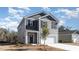 Charming two-story home featuring gray siding, black shutters, and an attached one car garage at 373 Acosta Circle, Conway, SC 29527