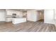 Inviting open-concept living space features wood-look flooring, and a modern kitchen with white cabinets at 373 Acosta Circle, Conway, SC 29527