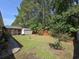 Large grassy backyard with fenced perimeter, utility shed, and patio at 3805 Mayfield Dr., Conway, SC 29526