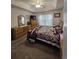 Cozy bedroom featuring a ceiling fan, dresser, and a comfortable bed with a charming patchwork quilt at 3805 Mayfield Dr., Conway, SC 29526