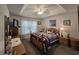Comfortable bedroom featuring a tray ceiling, neutral carpet, and a quilt-covered bed at 3805 Mayfield Dr., Conway, SC 29526