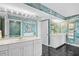 Bright bathroom featuring dual sinks, framed mirrors, and decorative, textured walls at 3805 S Ocean Blvd. # 503, North Myrtle Beach, SC 29582