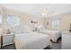 This bedroom includes two beds, neutral walls, a ceiling fan, and bright, natural light at 3805 S Ocean Blvd. # 503, North Myrtle Beach, SC 29582