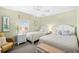 Bright bedroom featuring two twin beds, a bench, and a ceiling fan at 3805 S Ocean Blvd. # 503, North Myrtle Beach, SC 29582