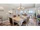 Elegant dining room with modern chandelier, adjacent living area, and ocean view balcony at 3805 S Ocean Blvd. # 503, North Myrtle Beach, SC 29582