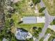 Aerial view of a stilt house, showcasing its expansive driveway and proximity to mature trees at 400 Elizabeth Dr., Murrells Inlet, SC 29576