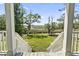 Picturesque backyard view from a porch featuring stairs and railings at 400 Elizabeth Dr., Murrells Inlet, SC 29576