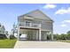 Stilt home with a spacious covered parking area and elevated deck, perfect for outdoor living at 400 Elizabeth Dr., Murrells Inlet, SC 29576
