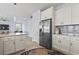 Stylish kitchen features white cabinetry, stainless steel appliances, and open access to the living area at 400 Elizabeth Dr., Murrells Inlet, SC 29576