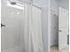 Modern shower with a sleek shower head and white shower curtain for privacy at 400 Elizabeth Dr., Murrells Inlet, SC 29576