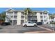 Three-story condo building with palm trees, parking, and white exterior paint in a coastal community at 400 Lands End Blvd. # 5304, Myrtle Beach, SC 29572