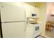 Updated kitchen featuring white appliances including range oven, microwave, refrigerator, and adjacent dining area at 400 Lands End Blvd. # 5304, Myrtle Beach, SC 29572