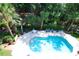 Inviting pool surrounded by lounge chairs, palm trees, and beautiful landscaping. An American flag waves in the breeze at 400 Lands End Blvd. # 5304, Myrtle Beach, SC 29572