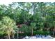 Relaxing pool area with lounge chairs, tables, and lush landscaping with tropical trees and an American flag waving gently at 400 Lands End Blvd. # 5304, Myrtle Beach, SC 29572