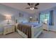 The main bedroom has a ceiling fan and a view to the exterior through a large window at 415 Ocean Creek Dr. # 2189, Myrtle Beach, SC 29572