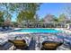 Enjoy the sunshine on lounge chairs surrounding the pristine community pool with shade at 415 Ocean Creek Dr. # 2189, Myrtle Beach, SC 29572
