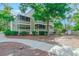 A charming multi-level home boasts screened-in porches and lush landscaping, enhancing its curb appeal in a tranquil setting at 415 Ocean Creek Dr. # 2189, Myrtle Beach, SC 29572