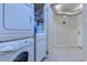 Well-organized laundry area with stacked washer/dryer, storage shelves, and a convenient laundry room at 415 Ocean Creek Dr. # 2189, Myrtle Beach, SC 29572