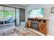 Stylish living room with a fireplace and a large screen television, adjacent to a lovely screened-in porch for relaxed outdoor lounging at 415 Ocean Creek Dr. # 2189, Myrtle Beach, SC 29572