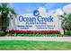 Prominent Ocean Creek Plantation sign with lush landscaping, marking the entrance to this resort at 415 Ocean Creek Dr. # 2189, Myrtle Beach, SC 29572