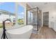 Bright bathroom with freestanding tub, luxurious glass enclosed shower and stunning view at 434 Harbour View Dr., Myrtle Beach, SC 29579