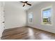 A bedroom with wood-look floors, two windows, and neutral wall paint at 434 Harbour View Dr., Myrtle Beach, SC 29579