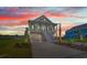 Exterior view of a beautiful multi-story home with covered porch, lovely landscape, and attached garage at 434 Harbour View Dr., Myrtle Beach, SC 29579