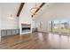 Open concept living room boasts a fireplace, vaulted ceilings, and hardwood floors at 434 Harbour View Dr., Myrtle Beach, SC 29579