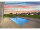 Backyard featuring a pool with a serene view of the neighborhood and vibrant sunset at 434 Harbour View Dr., Myrtle Beach, SC 29579