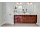 Well-lit bathroom featuring double vanities, a shower, and tile flooring at 4548 Marshwood Dr., Myrtle Beach, SC 29579