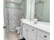 Well-lit bathroom with white cabinets, large mirror, and tub with shower at 4548 Marshwood Dr., Myrtle Beach, SC 29579