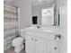 Bright bathroom featuring a white vanity with modern fixtures and a shower with a patterned curtain at 4548 Marshwood Dr., Myrtle Beach, SC 29579